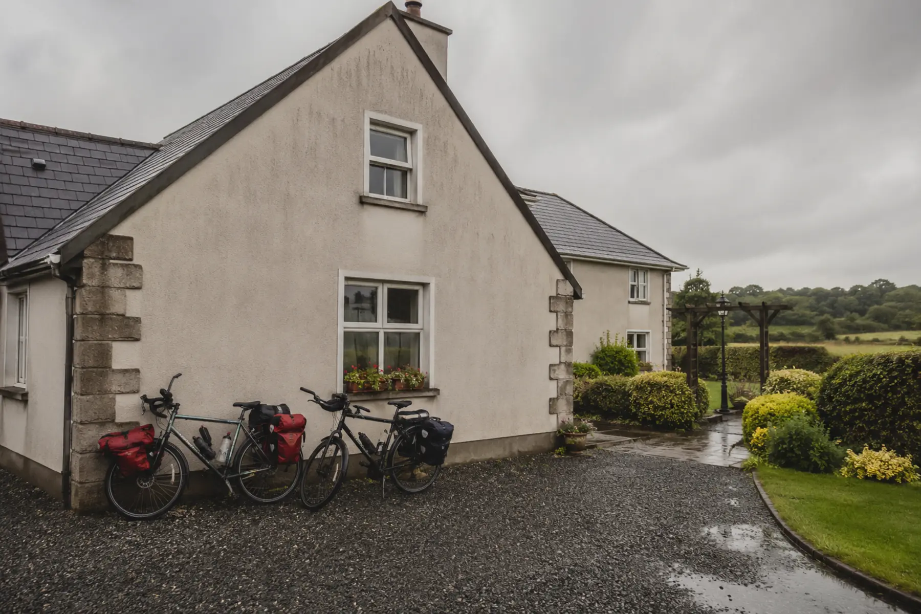 Touring bikes leaning at the gable of a B&B