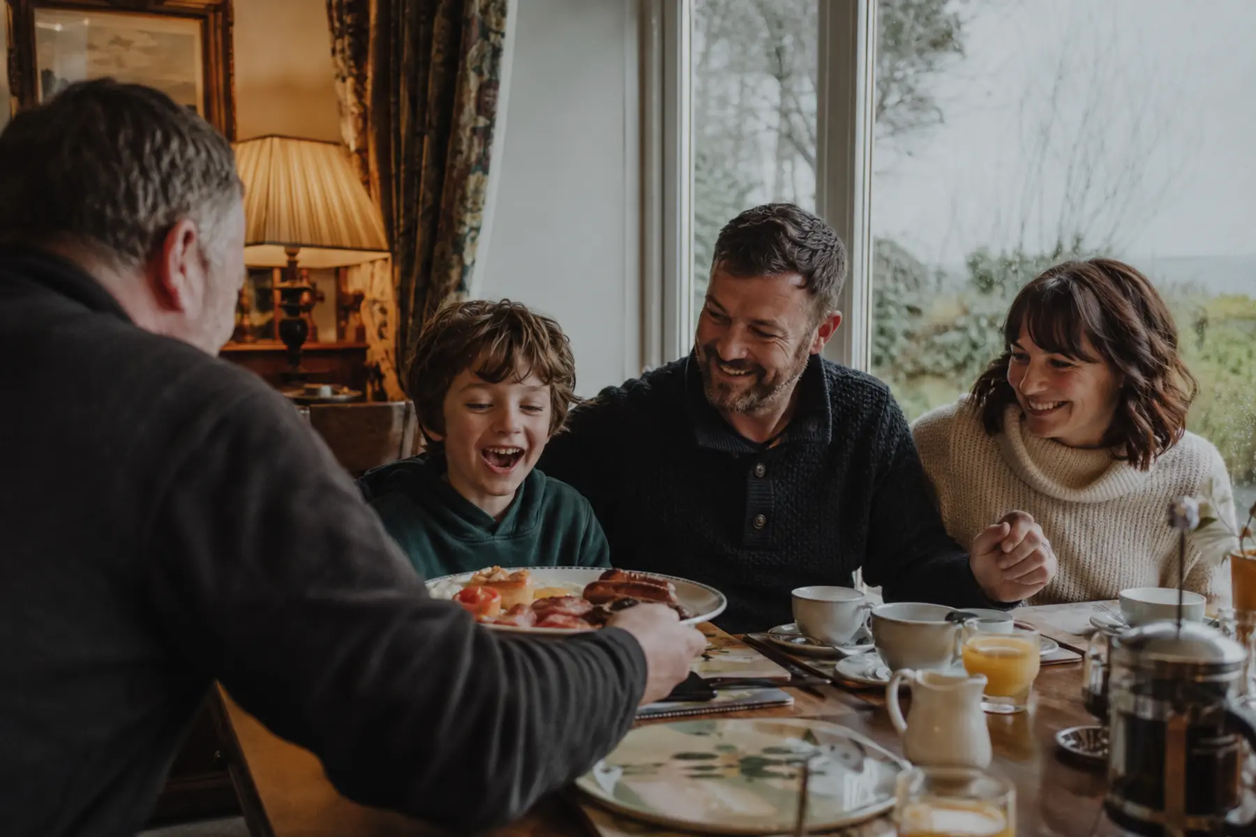 Family enjoying breakfast at an Irish B&B on a grey morning